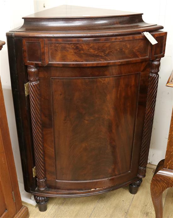 An early Victorian mahogany bowfronted standing corner cupboard, H.115cm